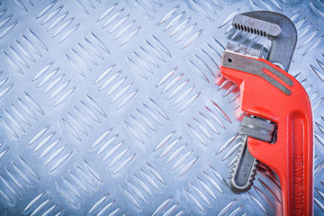 Metal monkey wrench on fluted metallic plate copy space construc