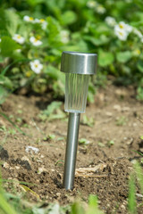 Charging solar lamp on the ground in the garden