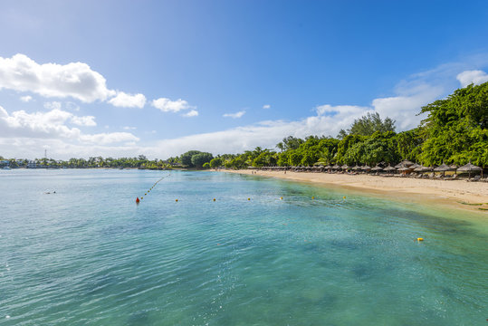 Mauritius beach umbrellas, thatch. Tropical Mauritius island water & beach resort, Turtle Bay - Balaclava