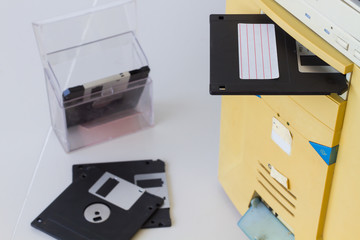 3.5-inch floppy disk in a floppy drive slot on a desktop computer
