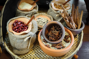 Spices herbs and seed beans in sacks and clay mortar, Local herbs in Thailand.