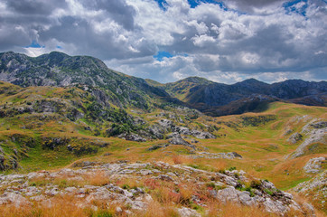 Montenegro, national park Durmitor, mountains and clouds panorama. Sunlight lanscape. Nature travel background.