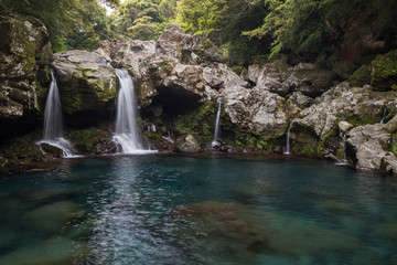 Obraz premium View of Wonang Falls and a pond on Jeju Island in South Korea.