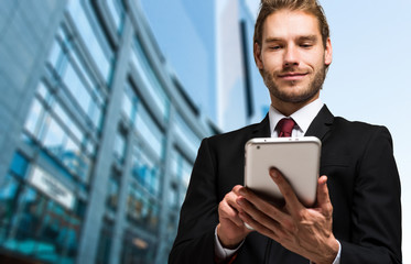 Portrait of a businessman using his tablet computer