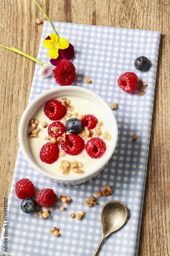 Wall mural Glass jar with fruits and whipped cream.