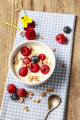 Glass jar with fruits and whipped cream.