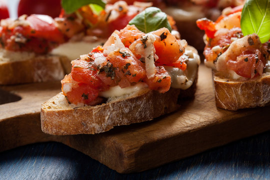 Italian bruschetta with roasted tomatoes, mozzarella cheese and