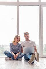 Beautiful young couple with gadget