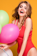 Girl with balloons posing in studio.