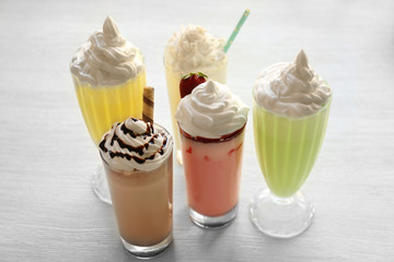 Delicious milkshakes on wooden table