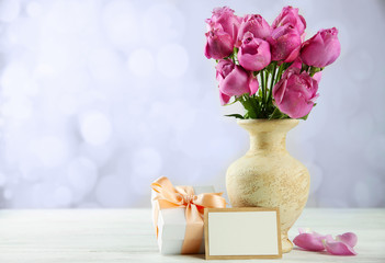 Mother Day concept. Roses with gift box on bokeh background