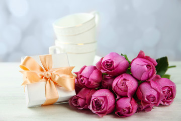 Fototapeta na wymiar Mother Day concept. Roses with gift box on bokeh background
