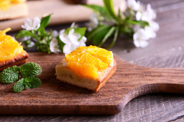 Delicious citrus cake on wooden background