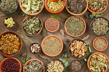 Natural flower and herb selection in wooden bowls, close up