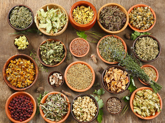 Natural flower and herb selection in wooden bowls, close up