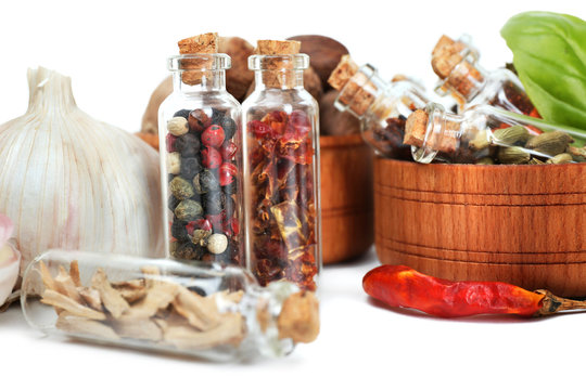 Assorted dry spices in glass bottles, close up