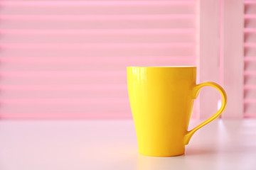 Cup on pink folding screen background
