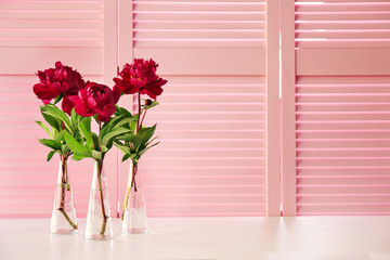 Beautiful peony flowers on pink folding screen background