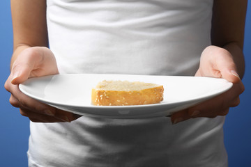 Woman on diet with small piece of bread