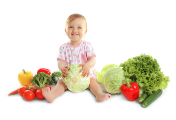 Cute baby girl with vegetables, isolated on white