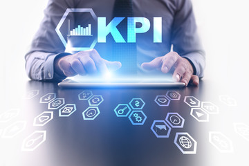 Fototapeta na wymiar Businessman is using tablet pc and selecting KPI icon.