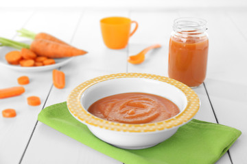 Carrot puree in soup plate on green napkin
