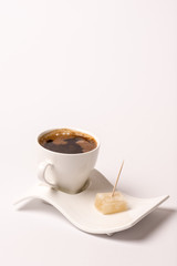 White cup of coffee with turkish delight over white background w