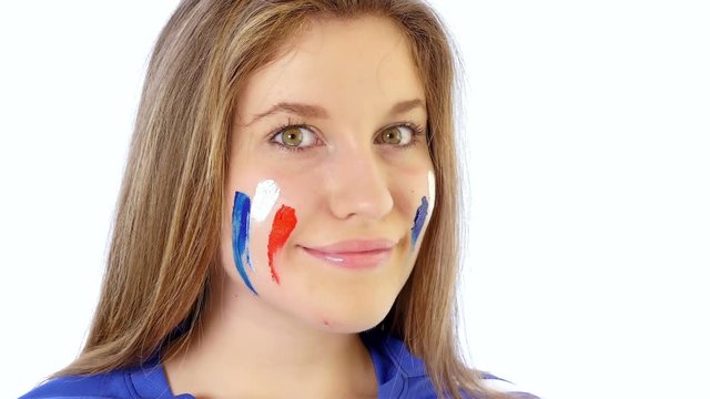 Girl painting her face with French flag