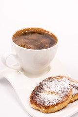 Cup of coffee with homemade donuts