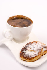 Cup of coffee with homemade donuts with powdered sugar