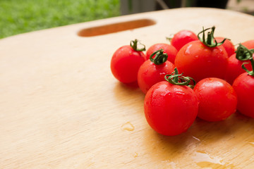 Cherry Tomato fresh group on wooden chopping board. lycopene and antioxidant in fruit nutrition good for health and skin
