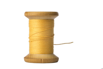 Yellow thread spool isolated on white background