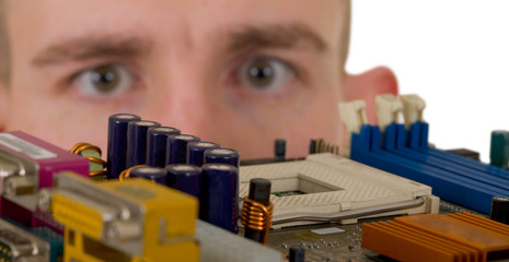 Man examines an electronic circuit
