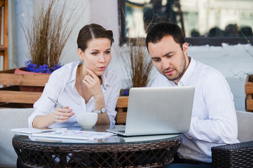 Successful manager sitting at business lunch with colleague and giving instructions to her