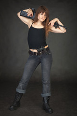 Beautiful young sexy woman with a rifle on shoulders