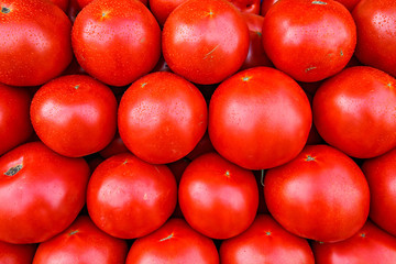 Fresh organic red tomatoes at a local farmers market.