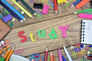 Study word and office tools on wooden table