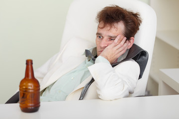 Fototapeta premium Young drunkard with hangover after holiday