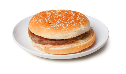 Stale hamburger on a plate isolated on white background
