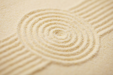 Fototapeta na wymiar Circle drawn on sand of Japanese rock-garden