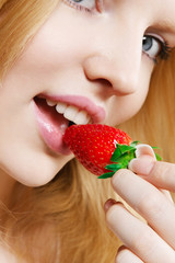 Girl eating strawberry