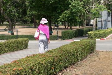 young woman walking in summer park