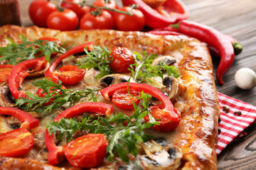 Freshly homemade pizza on wooden table closeup