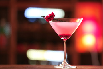 Glass of cocktail on bar background