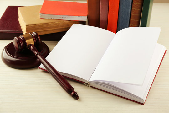 Blank open book with gavel on table