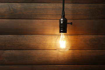 Light bulb on wooden background, close up