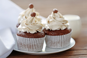 Tasty cupcakes on wooden table