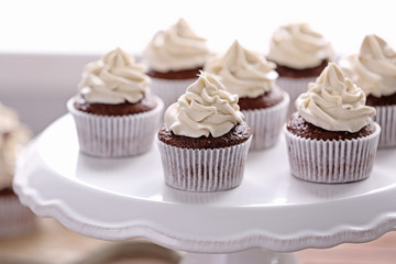 Tasty cupcakes on stand
