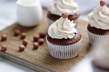 Tasty cupcake on cutting board, closeup