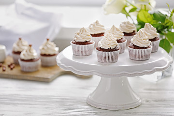 Tasty cupcakes on white stand